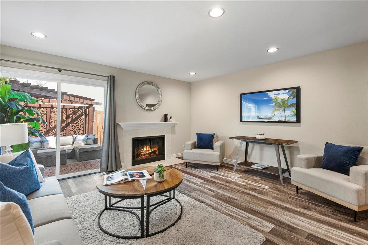101 Redding Road, Unit C5 Campbell, CA 95008 - Photo 4 of 25 a living room with furniture a fireplace and a large window