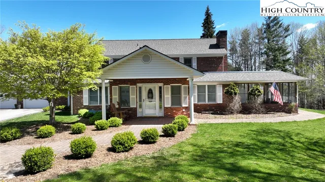 a front view of a house with a yard table and chairs