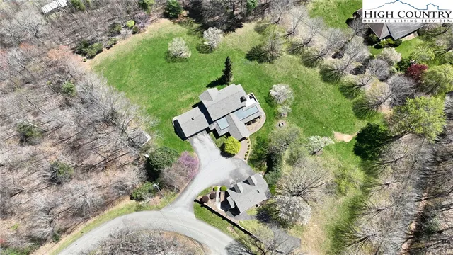an aerial view of a house with a yard and garden