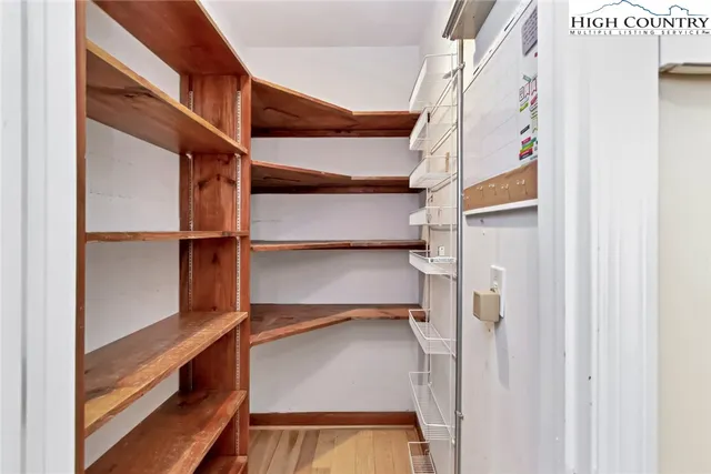 a view of walk in closet with empty racks