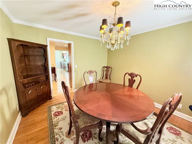 a view of a dining room with furniture wooden floor and a chandelier