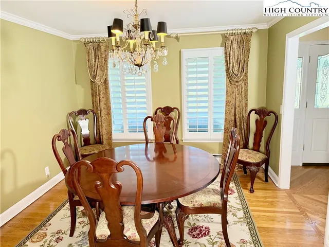 a dining room with furniture and wooden floor
