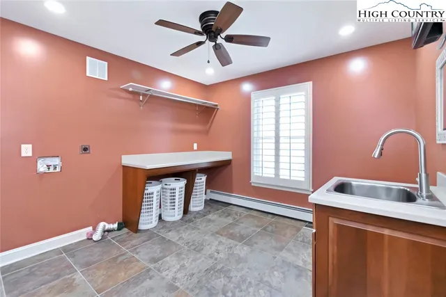 a bedroom with a sink and a window