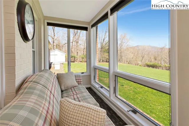 a living room with couch and a large window