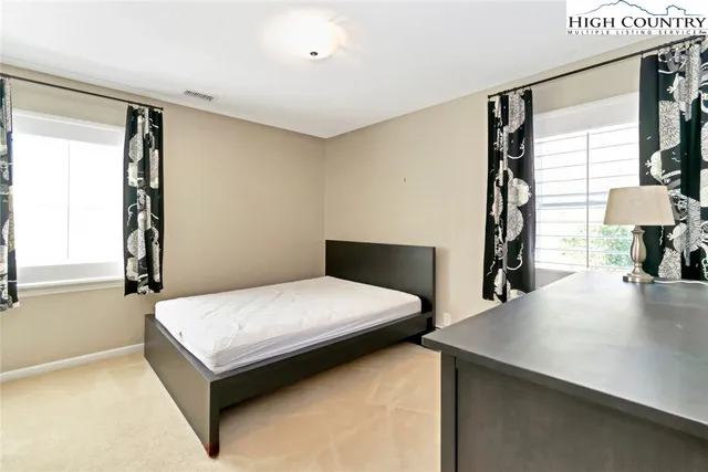 a bedroom with a bed and a table in it