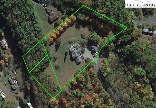 an aerial view of a house with a yard and a fountain