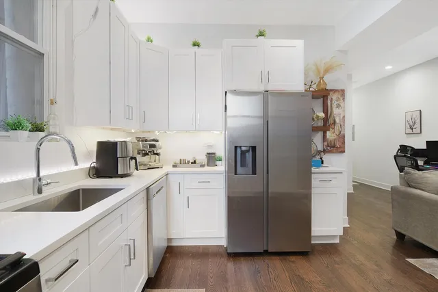 a kitchen with stainless steel appliances a refrigerator sink and cabinets