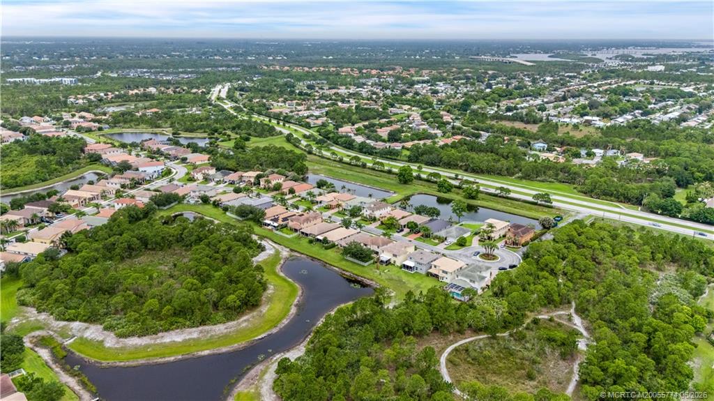 1268 Southeast Kirk Street Stuart, FL 34997 - Photo 58 of 63 an aerial view of residential houses with outdoor space and trees