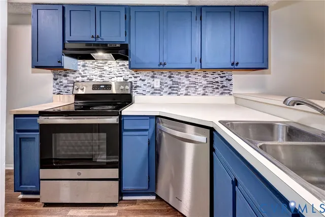 a kitchen with granite countertop wood cabinets and stainless steel appliances