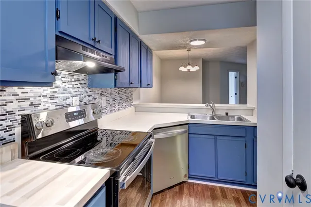 a kitchen with wooden cabinets and appliances