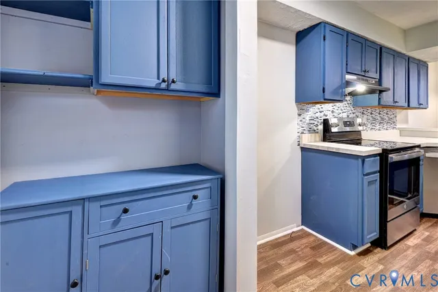 a kitchen with granite countertop cabinets and window