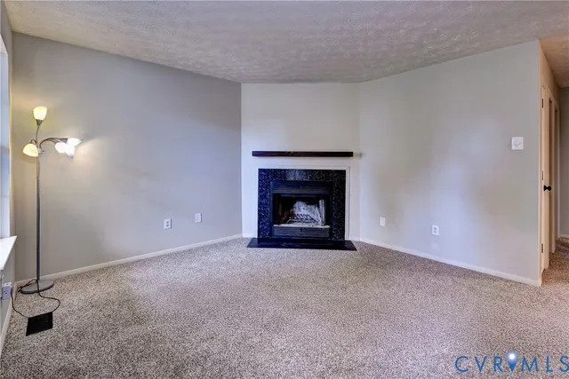 a view of an empty room with a fireplace