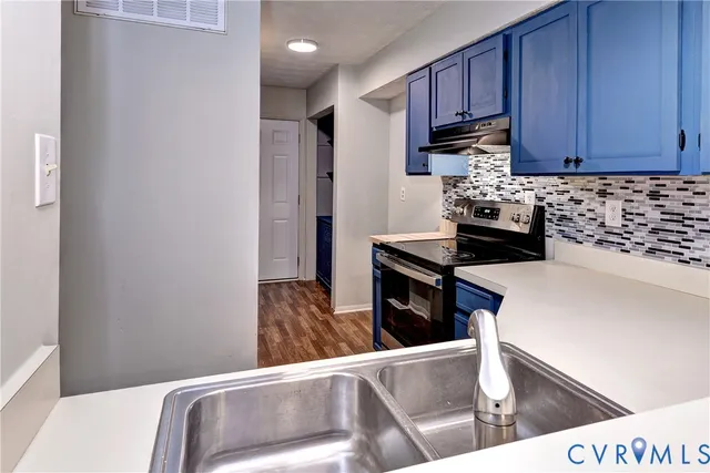 a kitchen with wooden cabinets and a stove top oven