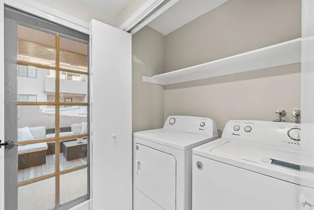 a view of storage and utility room with washer and dryer