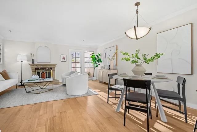 a living room with furniture a fireplace and a chandelier
