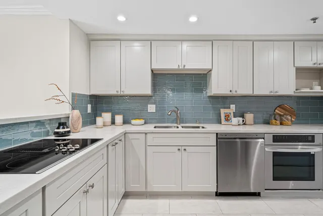 a kitchen with stainless steel appliances granite countertop a sink stove and cabinets