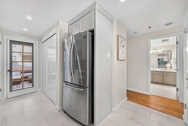 a kitchen with stainless steel appliances granite countertop a refrigerator and a stove top oven