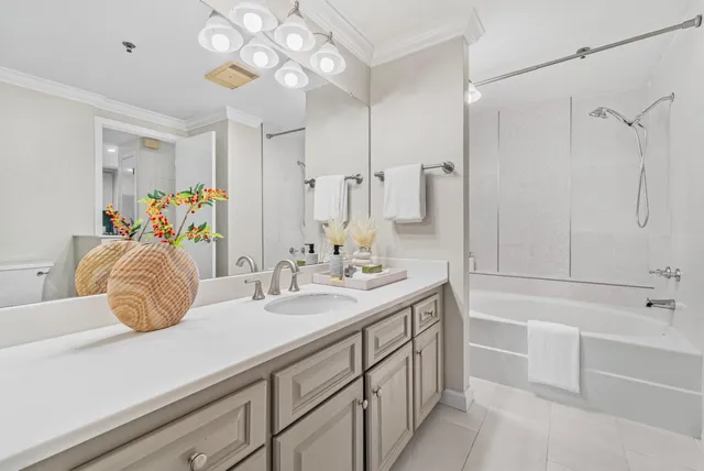 a bathroom with a double vanity sink a mirror a bathtub and shower