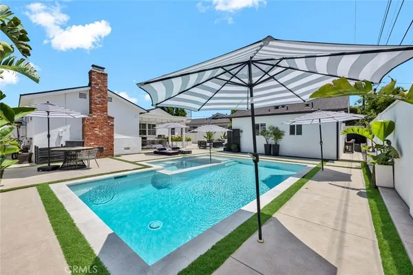 a view of a backyard with swimming pool
