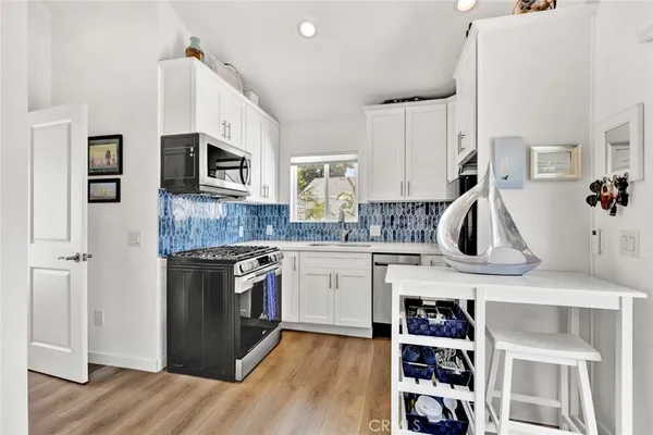 a kitchen with a sink a stove and cabinets