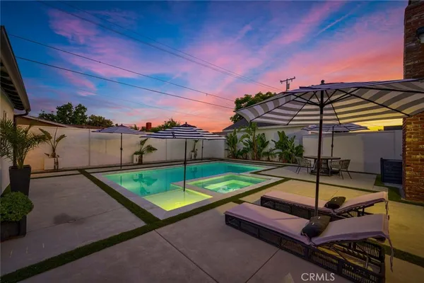 a backyard of a house with table and chairs