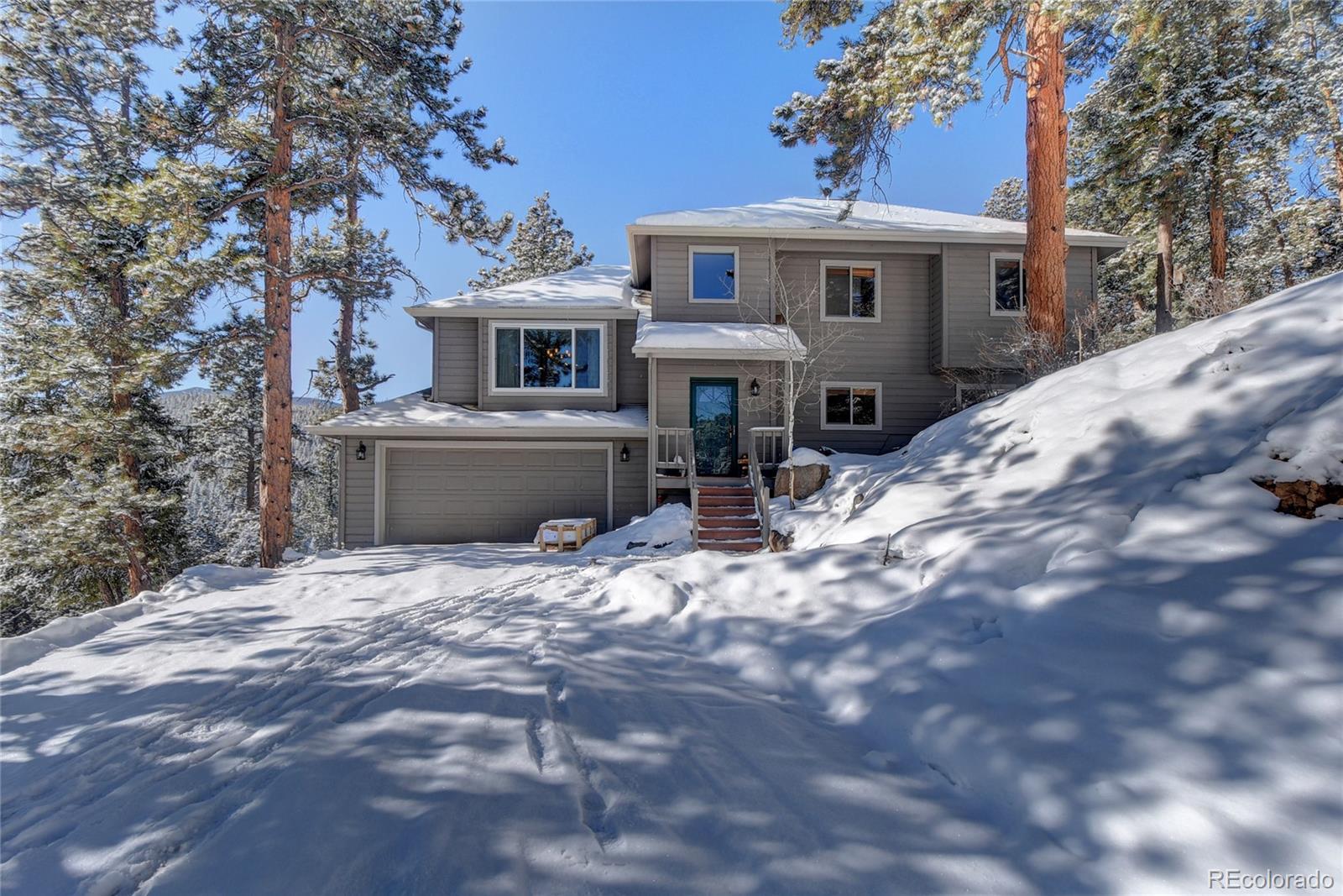 32787 Little Cub Road Evergreen, CO 80439 - Photo 1 of 40 a front view of a house with a yard