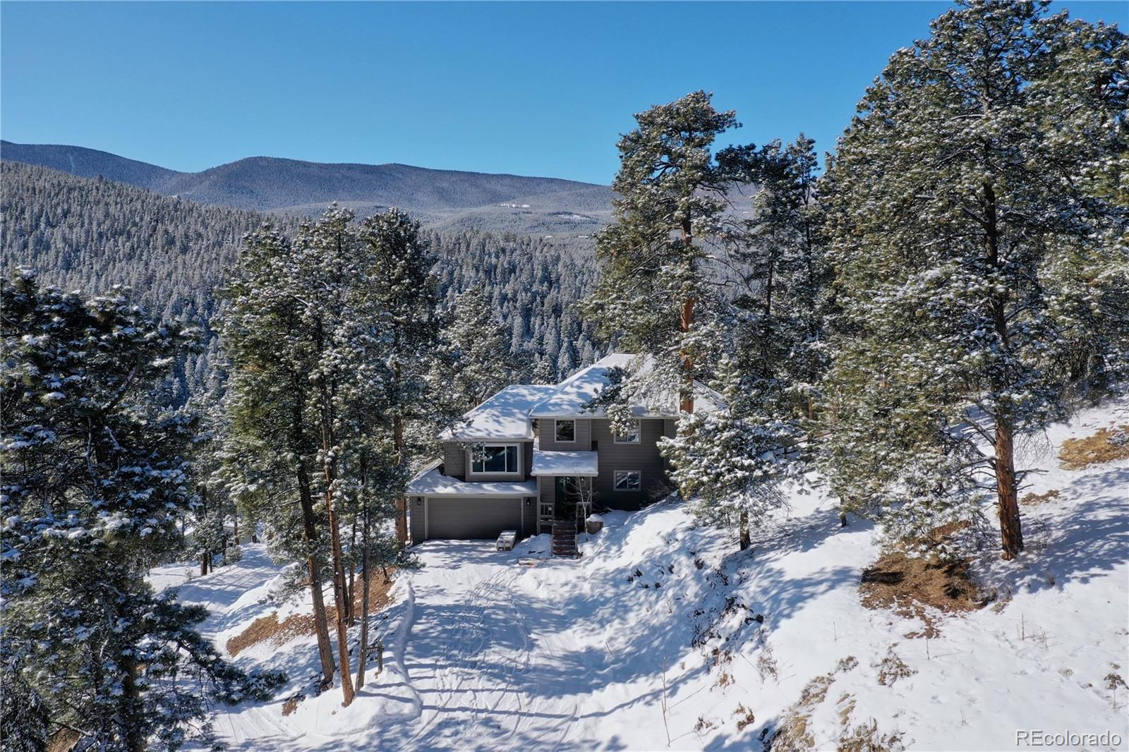 32787 Little Cub Road Evergreen, CO 80439 - Photo 38 of 40 a view of a house with a yard