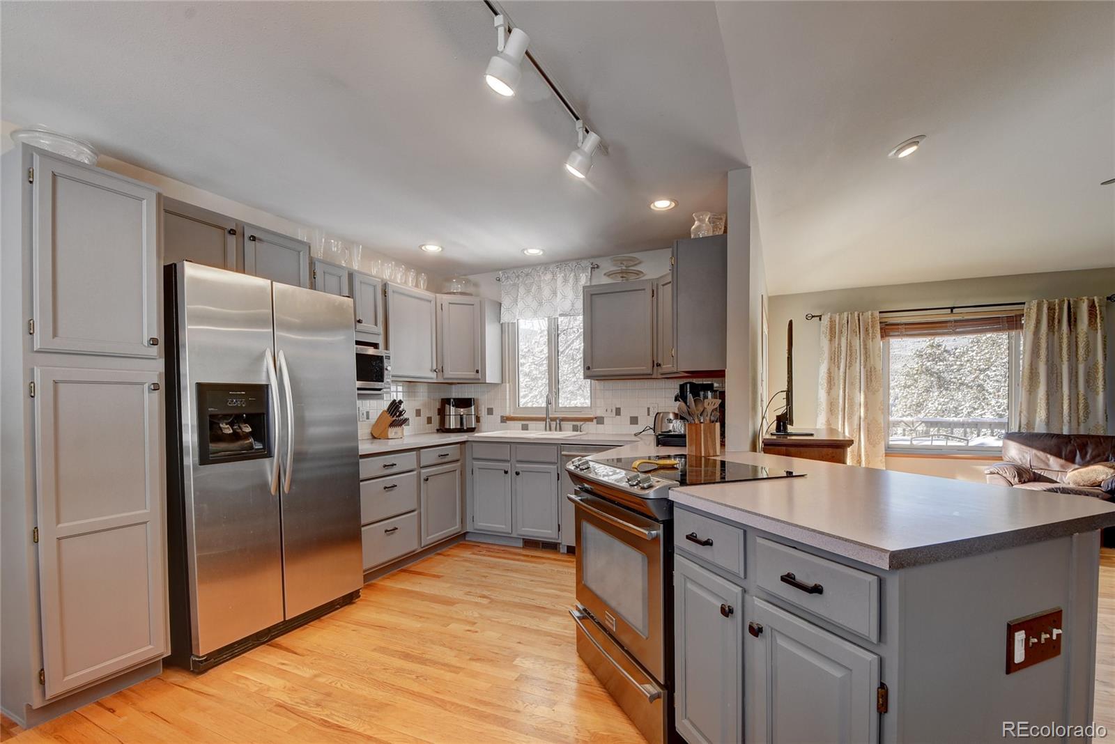 32787 Little Cub Road Evergreen, CO 80439 - Photo 7 of 40 a kitchen with refrigerator cabinets and furniture