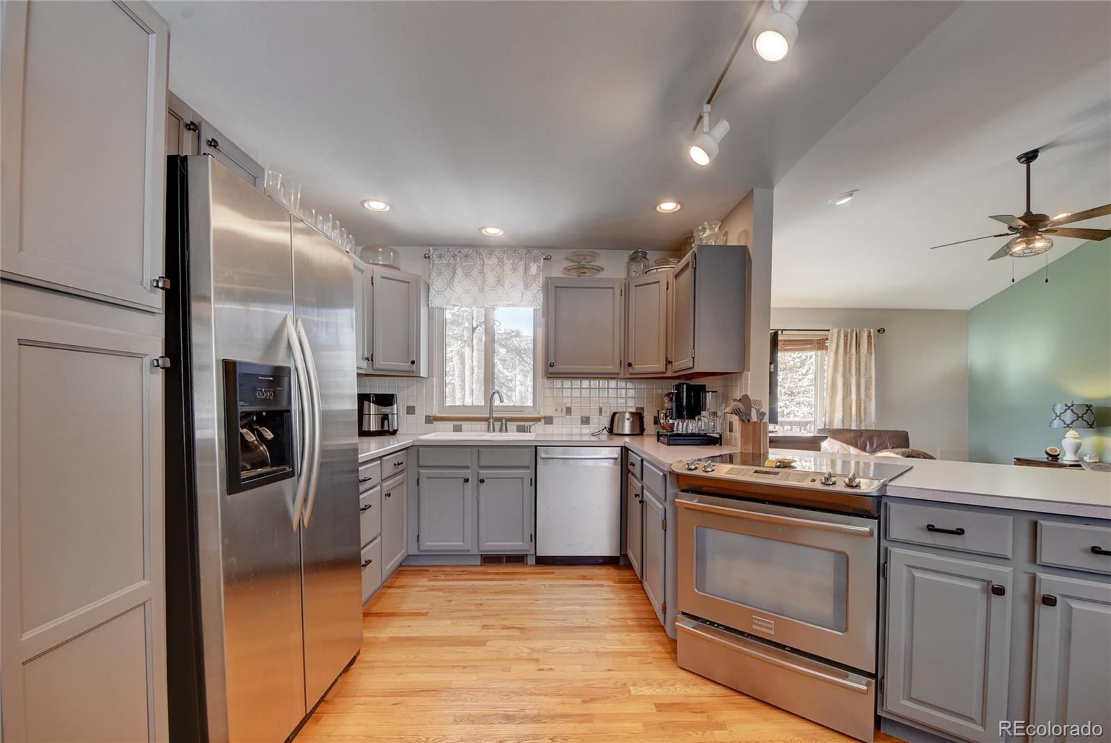 32787 Little Cub Road Evergreen, CO 80439 - Photo 8 of 40 a kitchen with a sink stainless steel appliances and cabinets