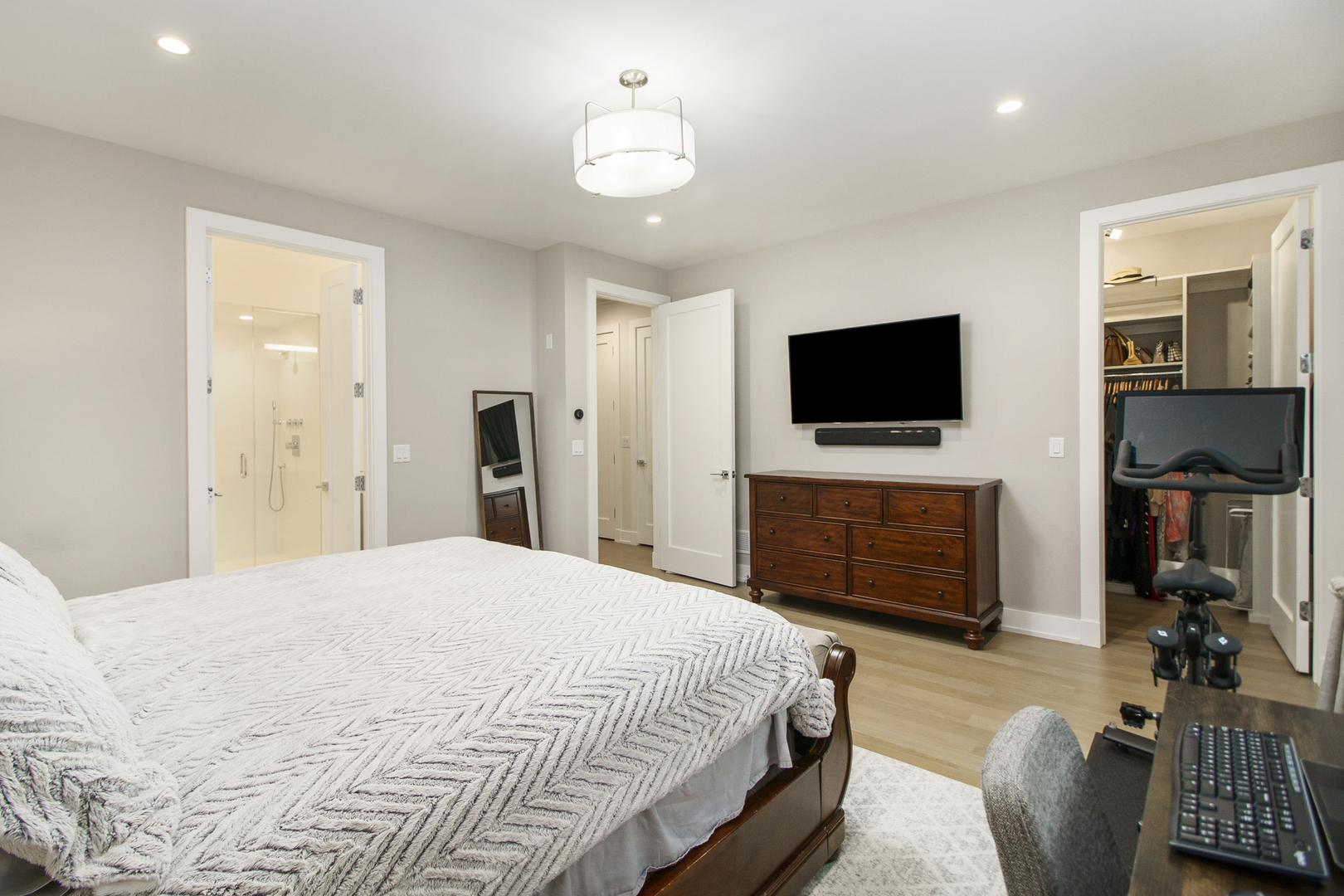 226 South Green Street, Unit 2N Chicago, IL 60607 - Photo 15 of 29 a spacious bedroom with a bed and a flat screen tv