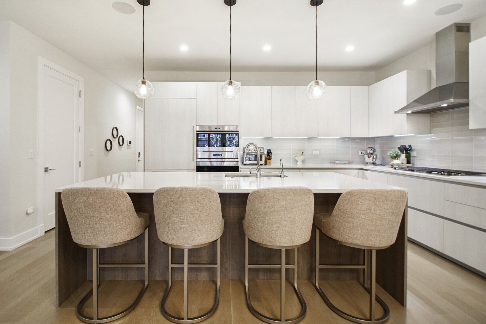 226 South Green Street, Unit 2N Chicago, IL 60607 - Photo 2 of 29 a kitchen with stainless steel appliances kitchen island granite countertop a dining table chairs and white cabinets