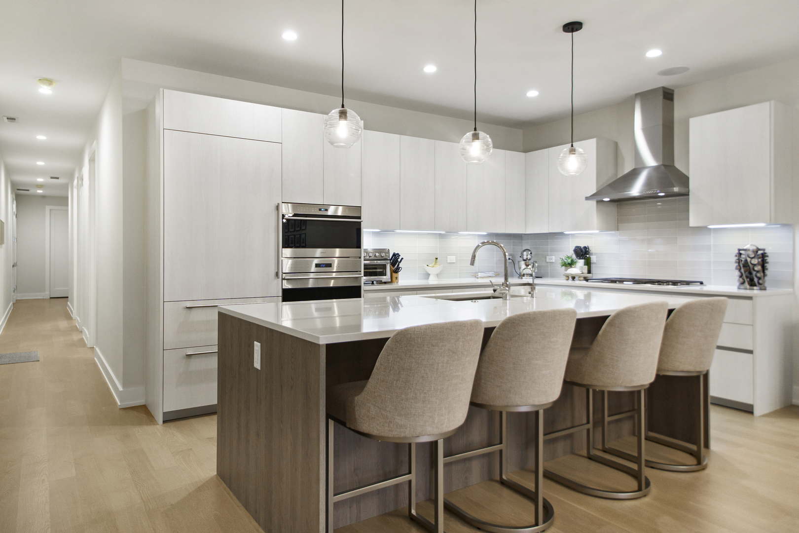 226 South Green Street, Unit 2N Chicago, IL 60607 - Photo 7 of 29 a kitchen with kitchen island granite countertop a sink a center island stainless steel appliances and cabinets