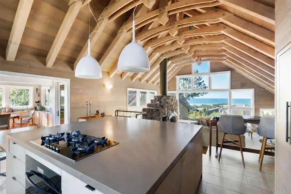 a kitchen with stove and chairs