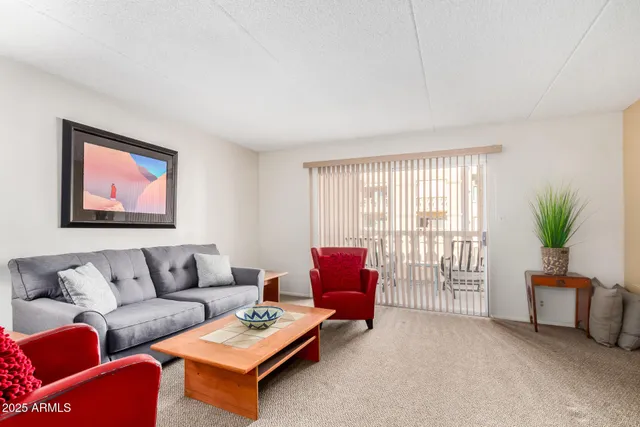 a living room with furniture and a potted plant