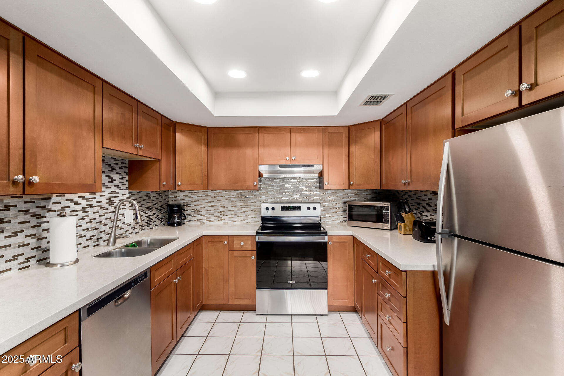 7920 East Camelback Road, Unit 608 Scottsdale, AZ 85251 - Photo 4 of 16 a kitchen with stainless steel appliances granite countertop a refrigerator stove sink and cabinets