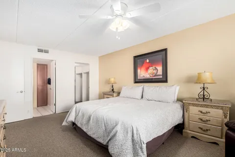 a bedroom with a bed and a lamp