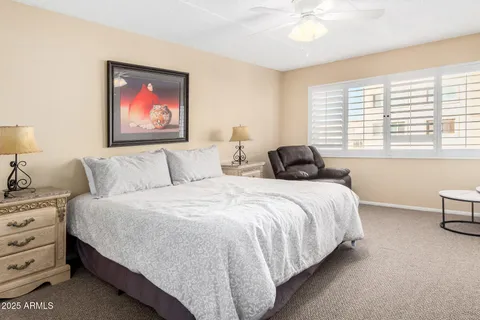 a bedroom with bed and a chandelier