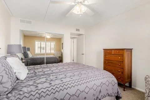 a bedroom with a bed and a dresser