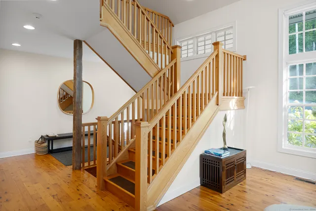 a view of entryway livingroom and hall with wooden floor