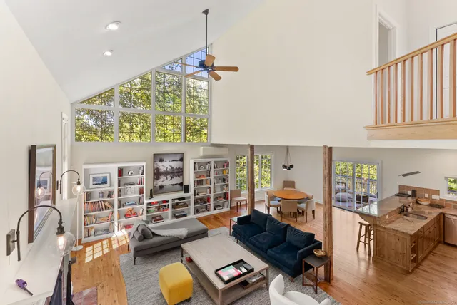 a living room with furniture and a floor to ceiling window