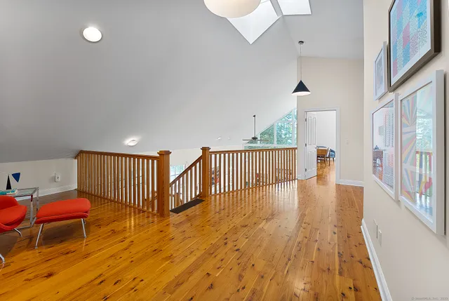 a view of a room with wooden floor