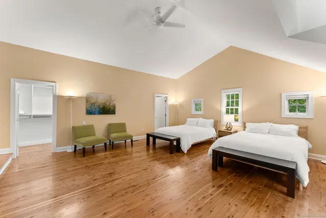 a bedroom with furniture and wooden floor