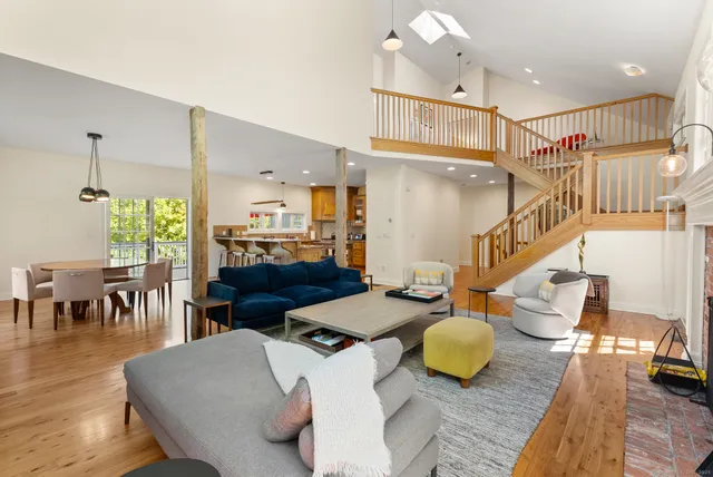a living room with furniture and kitchen view