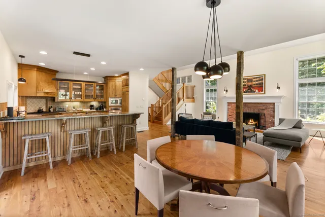 a living room with furniture a fireplace a flat screen tv and a table