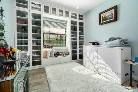 a bed room with a bed and a chair