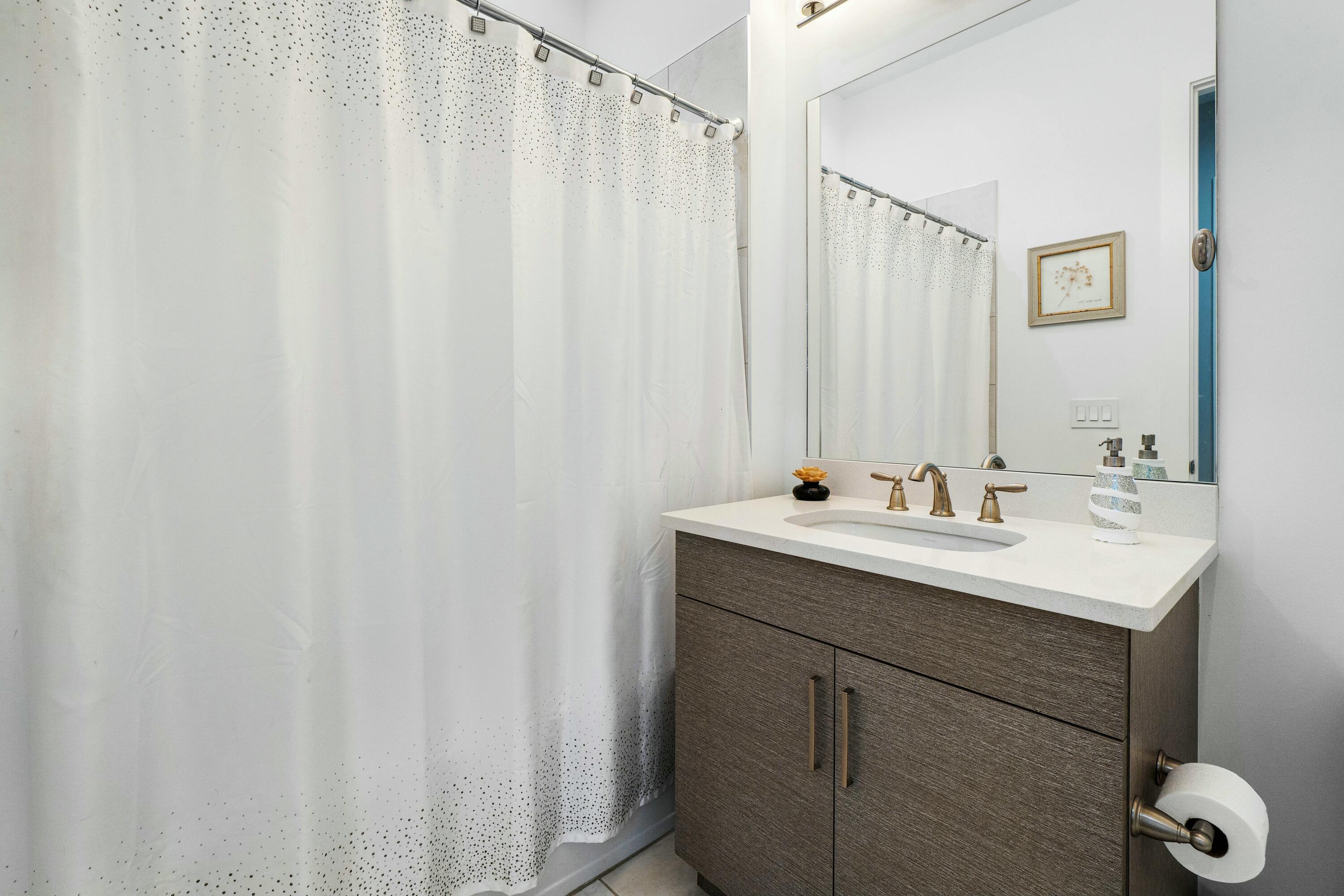 2928 Gin Berry Way West Palm Beach, FL 33401 - Photo 18 of 32 a bathroom with a double vanity sink and mirror