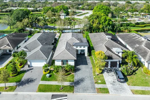 an aerial view of multiple houses with yard