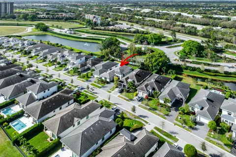 an aerial view of residential houses with outdoor space and swimming pool