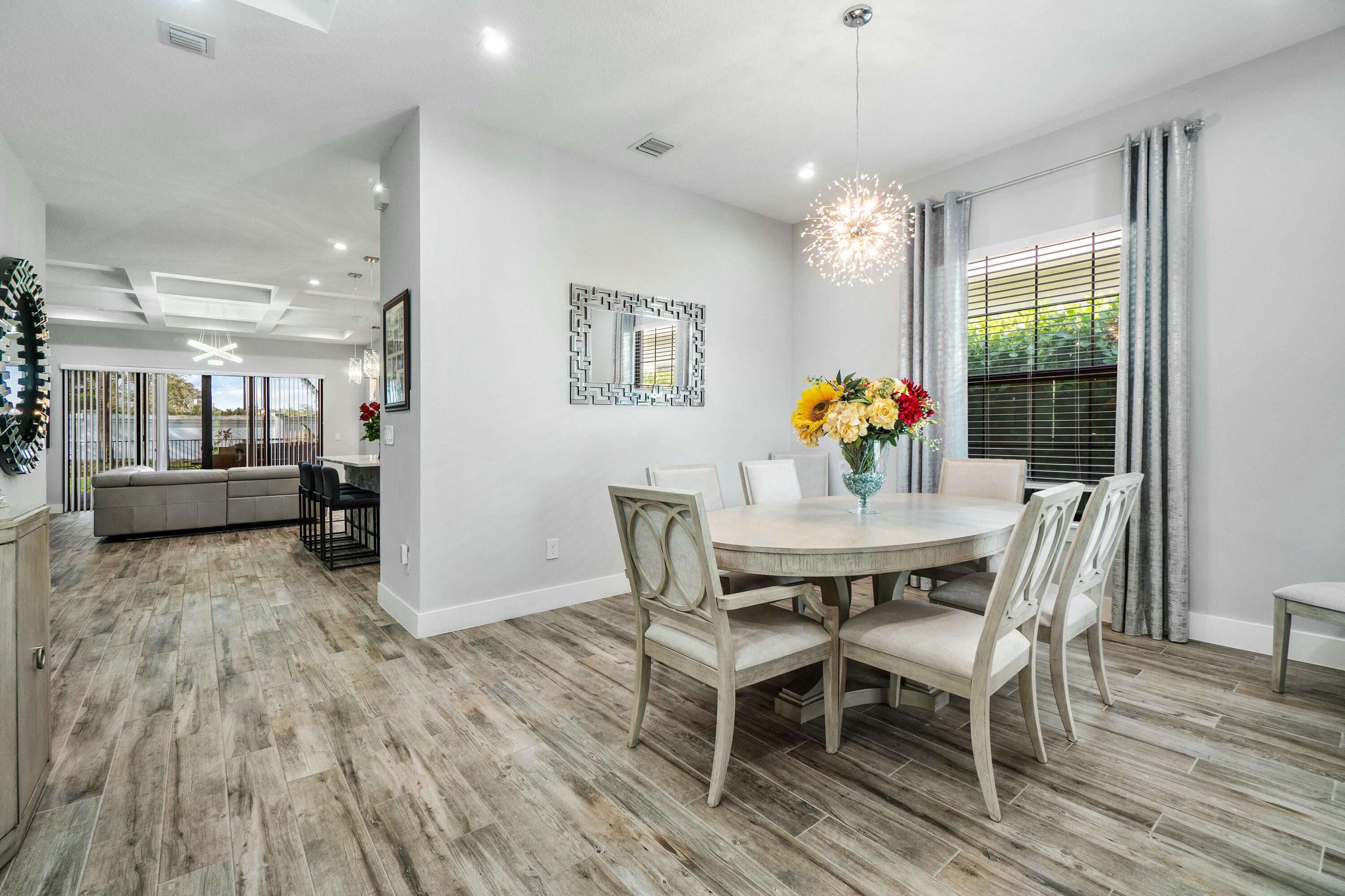2928 Gin Berry Way West Palm Beach, FL 33401 - Photo 4 of 32 a view of a dining room with furniture window and wooden floor