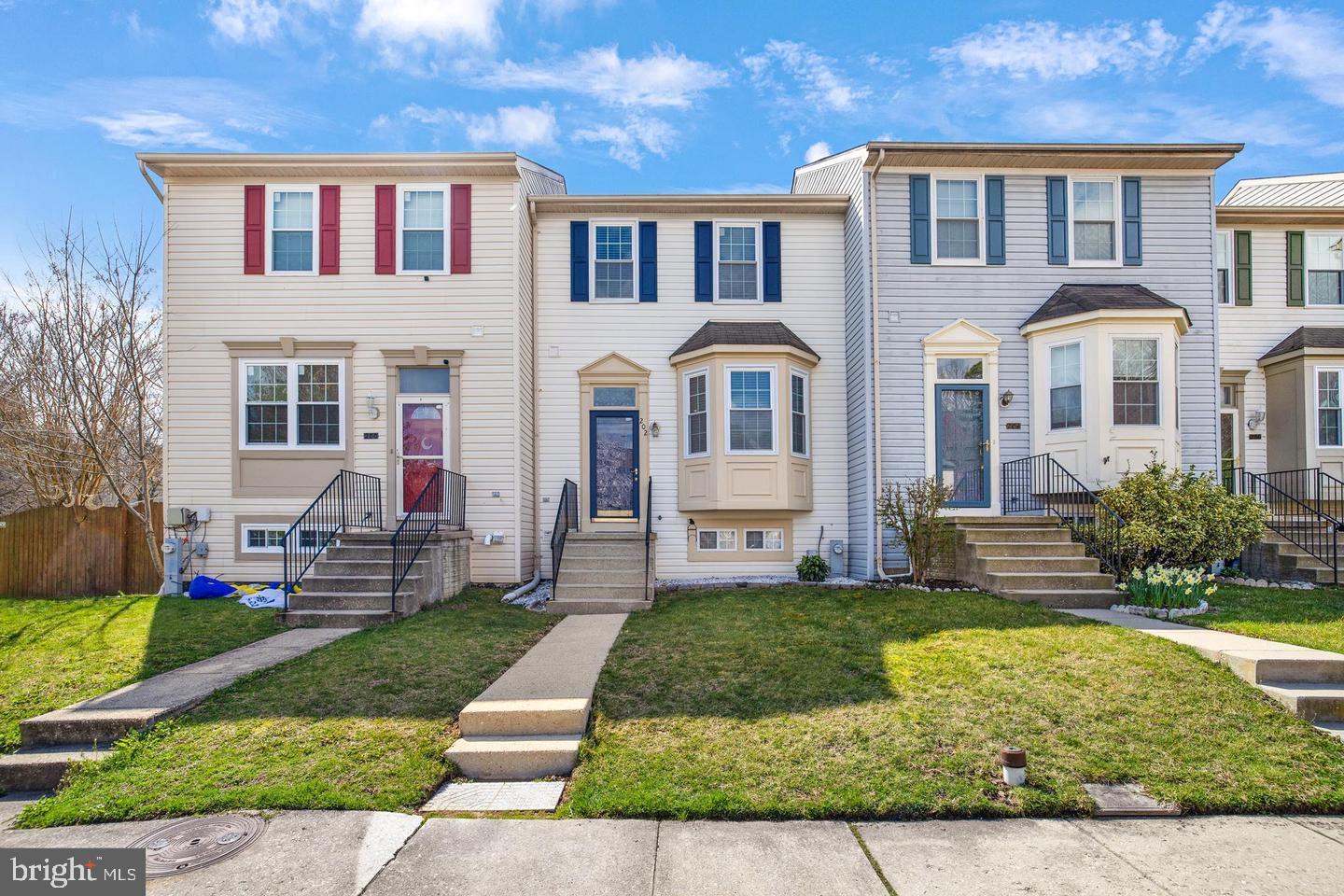 202 Mulberry Ridge Court Pasadena, MD 21122 - Photo 1 of 6 a front view of a house with a yard